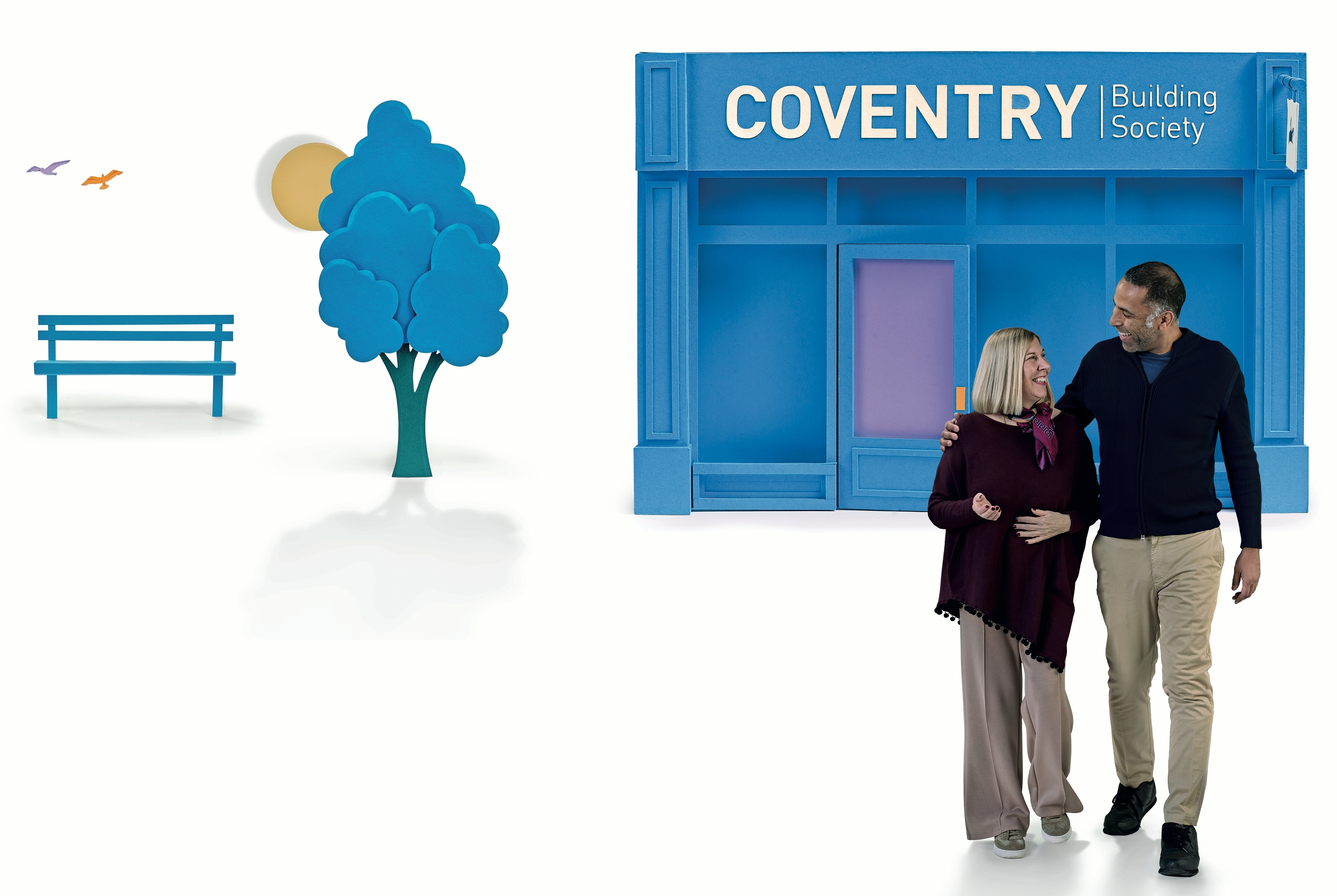 Image of two people stood in front of a Coventry bank branch