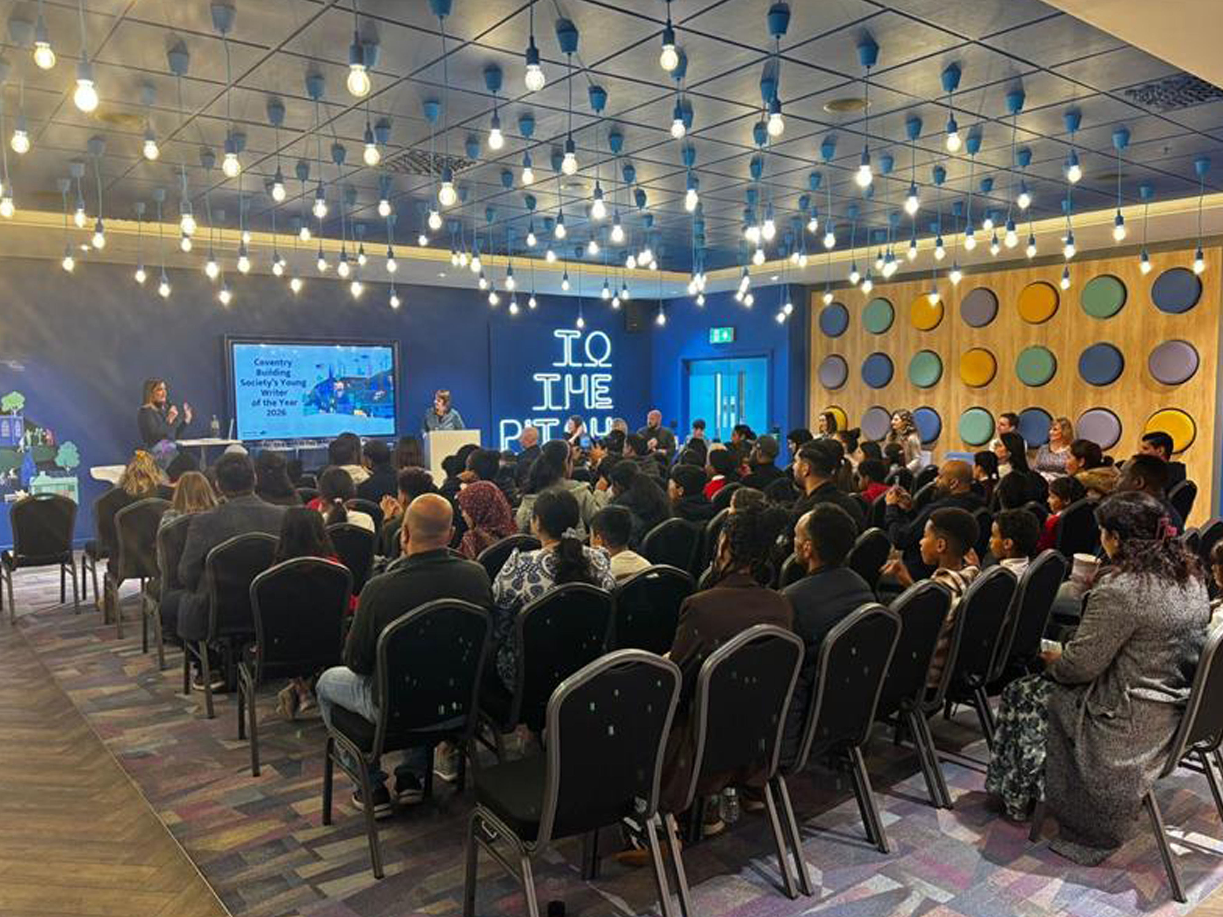 A wide shot of a conference happening in a meeting room in the CBS Arena 