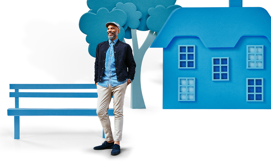 Photo of a man standing infront of a blue house