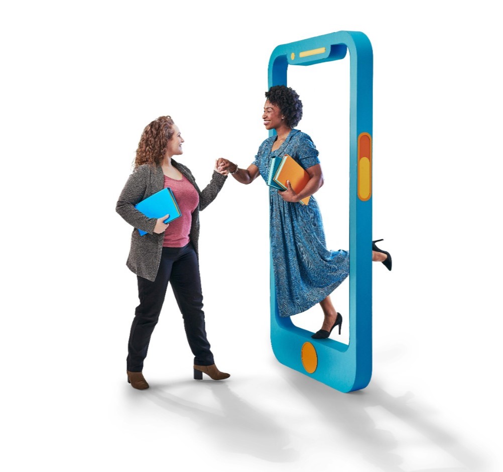 Woman stepping out of mobile phone holding hands with another woman facing her 